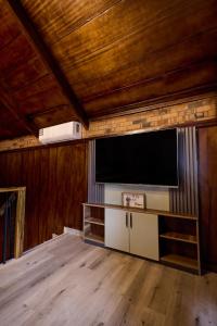 a living room with a flat screen tv on a wall at Premier Cabins in North Legon