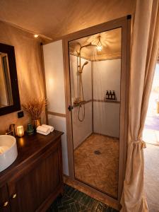 a bathroom with a shower and a sink at Hidden luxury Camp in Merzouga