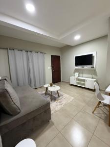 a living room with a couch and a flat screen tv at Dpto centro CDE in Ciudad del Este