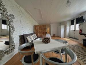 a living room with a couch and a table at Casa do Cacto - Studio Flat in Madalena +8 photos