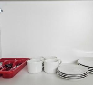 a group of white plates and a tray of dishes at Dpto centro CDE in Ciudad del Este