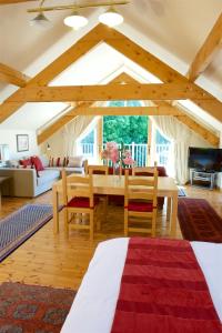 a living room with a wooden table and chairs at Cherryhill Lodge in Newcastle