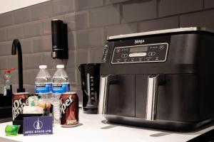 a microwave sitting on top of a kitchen counter at Luxury Serviced Apartment With Super King Bed Workspace WiFi & Netflix Washer Dryer Close Parking in Bradford