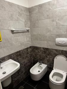 a bathroom with a toilet and a sink at Inis apartamans -50 m from beach in Shëngjin +19 photos