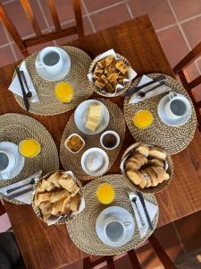 a table with plates of food and eggs and bread at El Paso Ibera Cabañas in Colonia Carlos Pellegrini
