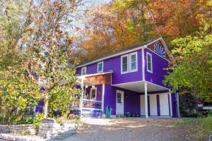 a purple house with trees in front of it at Cliff Cottage Inn, Downtown Bed & Breakfast in Eureka Springs