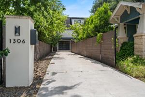 a sidewalk in front of a house with a fence at Spacious 5BR Central Austin Home Sleeps 13 in Austin