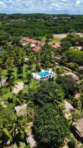 an aerial view of a resort with a swimming pool at Chalé 17 - Porto do Sol - Pipa in Pipa