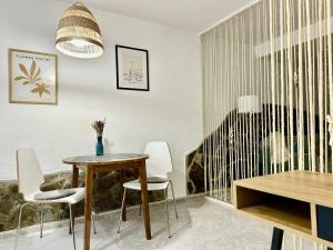 a dining room with a table and chairs and a window at BellaVista DM private pool in San Bartolomé +21 photos