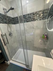 a bathroom with a shower and a sink at Dougs house in Niagara Falls +6 photos
