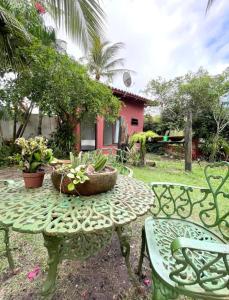 a table and two chairs with plants on it at Casa das Flores in Prado +13 photos