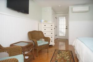 a bedroom with a bed and a tv on the wall at Marginal Way House in Ogunquit