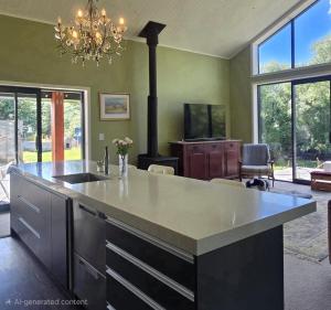 a kitchen with a large island with a stove at Riverside Retreat in Twizel +9 photos