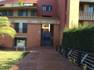 a building with a brick walkway in front of it at Hipalis Palmera in Seville