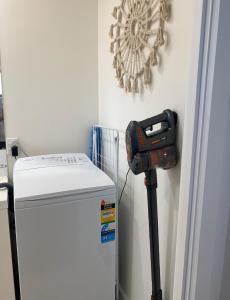 a machine is next to a white refrigerator at Coronet Bay Beach Cabin in Coronet Bay
