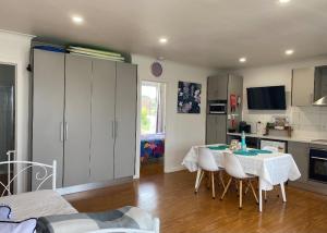 a kitchen and dining room with a table and chairs at Coronet Bay Beach Cabin in Coronet Bay