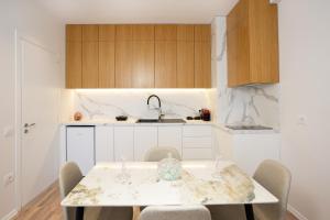 a kitchen with a table with chairs and a sink at TAO Apartment 2 in Tirana