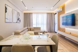 a living room with a table and a couch at TAO Apartment 2 in Tirana