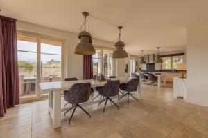 a kitchen and dining room with a table and chairs at Binnenduyn 2 in Buren