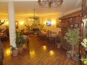 a dining room with tables and chairs and a brick wall at Hotel Lido in Prishtinë