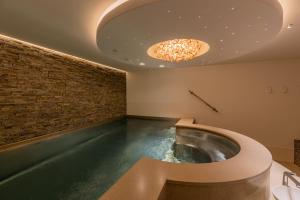 an indoor swimming pool with a bathtub in a room at Binnenduyn 2 in Buren +83 photos