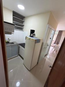 a kitchen with a refrigerator and a stove at Studio 302 Centro Imperial in Petrópolis