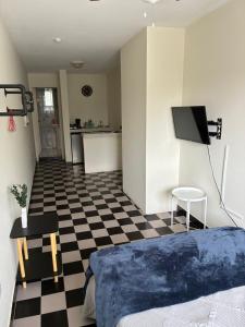 a bedroom with a bed and a checkered floor at Depa 1 sf2 in Hermosillo