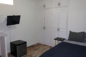 a bedroom with a bed and a flat screen tv at Depa 1 sf2 in Hermosillo