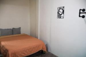 a small bedroom with a bed in a white room at Depa 1 sf2 in Hermosillo