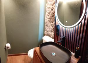 a bathroom with a sink and a mirror at Cabañas La Cascada in Tepoztlán +15 photos