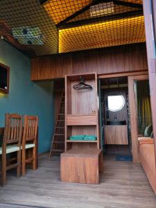 a room with wooden furniture and a table and chairs at Cabañas La Cascada in Tepoztlán