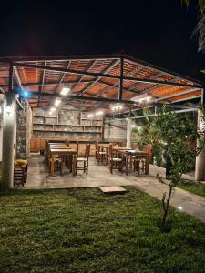 a patio with tables and chairs at night at Cabañas La Cascada in Tepoztlán