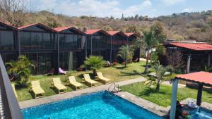 a view of a resort with a swimming pool at Cabañas La Cascada in Tepoztlán