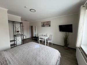 a bedroom with a bed and a table and a television at Medelby Inn in Medelby