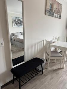 a bedroom with a mirror and a table and a bed at Medelby Inn in Medelby