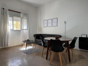 a living room with a table and a couch at Apto Mitre in San Juan