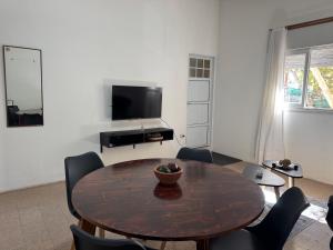 a living room with a table and chairs and a television at Apto Mitre in San Juan +11 photos
