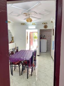 a dining room with a purple table and chairs at Dallas Surf Apartment in Agadir