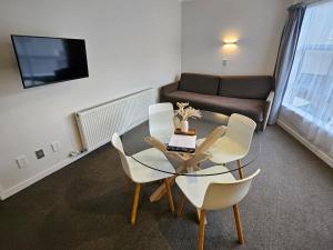 a living room with a table and chairs and a couch at RotoVegas Motel of Rotorua in Rotorua
