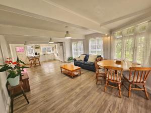 a living room with a table and a couch at 21 Villa in Whangarei
