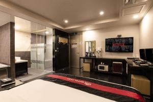 a hotel room with a bed and a bathroom at Camp Hotel in Seoul