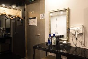 a bathroom with a sink and a mirror at Camp Hotel in Seoul +12 photos
