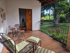 a balcony with chairs and a table and a table at Flat 01 Carvalhos de Aldeia km5 in Recife