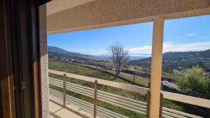 a window with a view of a mountain view at Casa das Quintas com vista para a montanha in Boticas