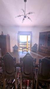a living room with two chairs and a ceiling fan at Casa das Quintas com vista para a montanha in Boticas