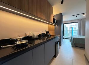 a kitchen with a sink and a bed in a room at Flat Beach Class Meireles in Fortaleza +32 photos