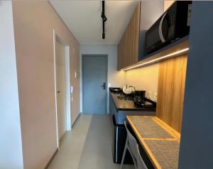 a kitchen with a sink and a counter top at Flat Beach Class Meireles in Fortaleza