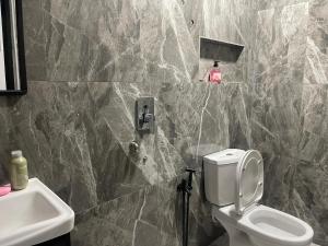 a bathroom with a toilet and a sink at The Bunker StudioStay in Arau +70 photos