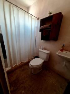 a dirty bathroom with a toilet and a sink at Cabaña Marmolejo in Arteaga +29 photos