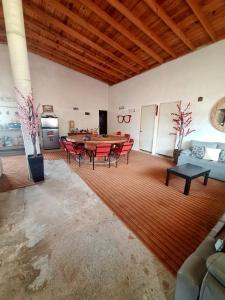 a large living room with a table and chairs at Cabaña Marmolejo in Arteaga